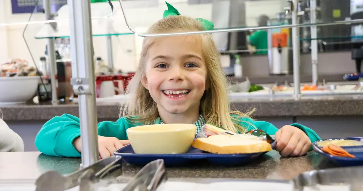 Student smiling with their food
