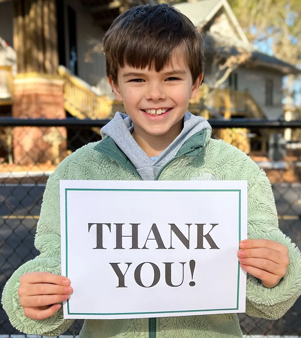 Student holding thank you card