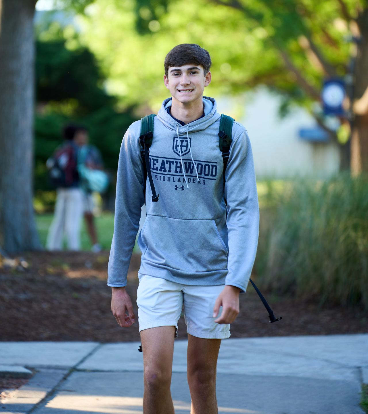 upper school student walking on sidewalk